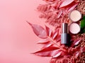 Various cosmetic products on pink background with copyspace, lipstic, brushes, powder