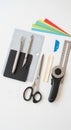 Various craft tools on a white surface include a cutting mat, utility knives, scissors, an Royalty Free Stock Photo