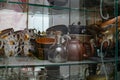 Various crockery under glass in a sideboard, plates and mugs in an old cupboard, a set and set of props for filming and preparing