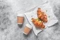 Various croissant sandwich and coffee in paper cups on gray grunge background. Top view, flat lay. Royalty Free Stock Photo