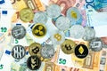 Various cryptocurrency coins on euro banknotes. Bitcoin, ethereum, litecoin and others modern virtual currency. Digital crypto