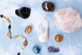 Various crystals or raw gemstone minerals with light blue background.