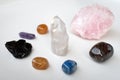 Various crystals or raw gemstone minerals with white background.