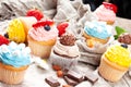 Various cupcakes on canvas. On a wooden table Royalty Free Stock Photo