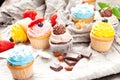 Various cupcakes on canvas. On a wooden table Royalty Free Stock Photo