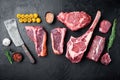 Various cuts of marbled beef meat and dry aged steaks, tomahawk, t bone, club steak, rib eye and tenderloin cuts, on black stone Royalty Free Stock Photo