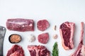 Various cuts of marbled beef meat and dry aged steaks, tomahawk, t bone, club steak, rib eye and tenderloin cuts, on white stone Royalty Free Stock Photo