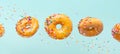 Various decorated donuts in motion falling on a blue background. Sweet and iced donuts fall or fly in motion. With caramel. Royalty Free Stock Photo