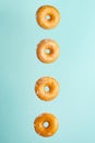 Various decorated donuts in motion falling on a blue background. Sweet and iced donuts fall or fly in motion. With coconut flakes Royalty Free Stock Photo