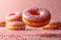 Various decorated donuts in motion falling on pink background. Royalty Free Stock Photo