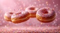 Various decorated donuts in motion falling on pink background. Royalty Free Stock Photo