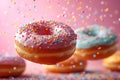 Various decorated donuts in motion falling on pink background.