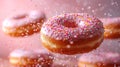 Various decorated donuts in motion falling on pink background.