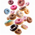Various decorated doughnuts in motion falling on white background Royalty Free Stock Photo