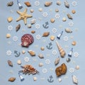 Various decorative nautical items, seashells, sea stars and miniature toys on blue pastel background. Sea travel, summer vacation