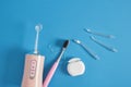 various dentifrices on a blue background, a set of teeth cleaning, dental floss, brush, irrigator, toothpaste, Royalty Free Stock Photo