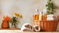 Various detergents for washing and cleaning, colored towels in wicker basket, on light tabletop with green plants