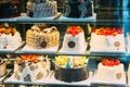 Various Different Types Of Sweet Cakes In Pastry Shop Glass Display. Good Assortment Of Confectionery Royalty Free Stock Photo