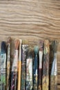 Various dirty paintbrush arranged in a row