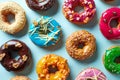 Various donuts on blue background, from above