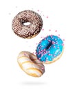 Various donuts with motley glaze in the air on a white background Royalty Free Stock Photo