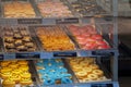 Various of donuts on a tray in a display case