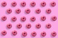 Colorful tasty donuts on pink background. Many donuts on bright background Royalty Free Stock Photo