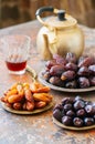 Various of dried dates or kurma in a vintage plates and tea