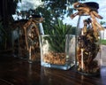 Various dried flowers and artificial flowers in the close bottle on wooden table