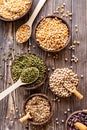 Various dried legumes in wooden bowls top view flat lay on wooden background Royalty Free Stock Photo