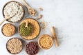Various dried legumes in wooden bowls top view flat lay on white marble background Royalty Free Stock Photo