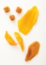 Various dried sweet mango slices and balls on white background Royalty Free Stock Photo