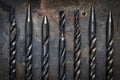 Various drill bits neatly arranged on a table, suitable for construction projects Royalty Free Stock Photo