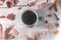 Various dry leaves and flowers around a cup of hot coffee, autumn decoration