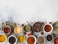 Various dry spices flat lay in small bowls on gray background. Top view, copy space