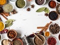Various dry spices frame flat lay in small bowls on white wood background. Top view, copy space Royalty Free Stock Photo