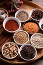 Various dry spices and herbs in a bowl on bamboo tray. Asian food ingredients