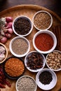 Various dry spices and herbs in a bowl on bamboo tray. Asian food ingredients