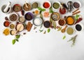 Various dry spices in small bowls and raw herbs flat lay on white background. Top view, copy space Royalty Free Stock Photo