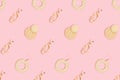 Various earrings pattern on a pink pastel background.