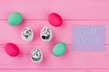 Various Easter eggs on pink background.