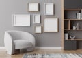 Various empty picture frames on gray wall in modern room. Mock up interior in contemporary style. Free, copy space for