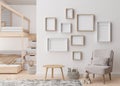 Various empty picture frames on white wall in modern child's room. Mock up interior in contemporary, scandinavian Royalty Free Stock Photo