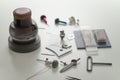 Various engraver goldsmith tools and object on white desk Royalty Free Stock Photo