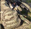 Rifles, camouflage backpack and uniform, ammunition on military range, army weapon of active game airsoft