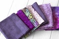 Various fabric material sample swatches, with a purple theme