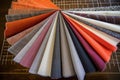 various fabric swatches fanned out on tailors work surface Royalty Free Stock Photo