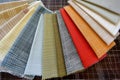 various fabric swatches fanned out on tailors work surface Royalty Free Stock Photo