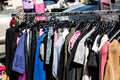 Various fast fashion female clothes on rack at street fair