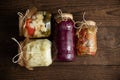 Various fermented, pickled, salted, canned vegetables in glass jars on a wooden table. Preparations for the winter of cauliflower Royalty Free Stock Photo